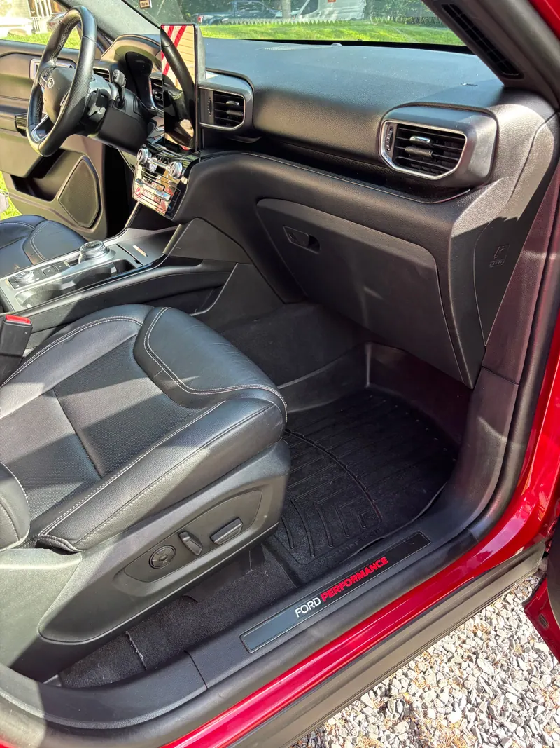 Passenger side of the Ford Explorer, black leather seat and dashboard cleaned