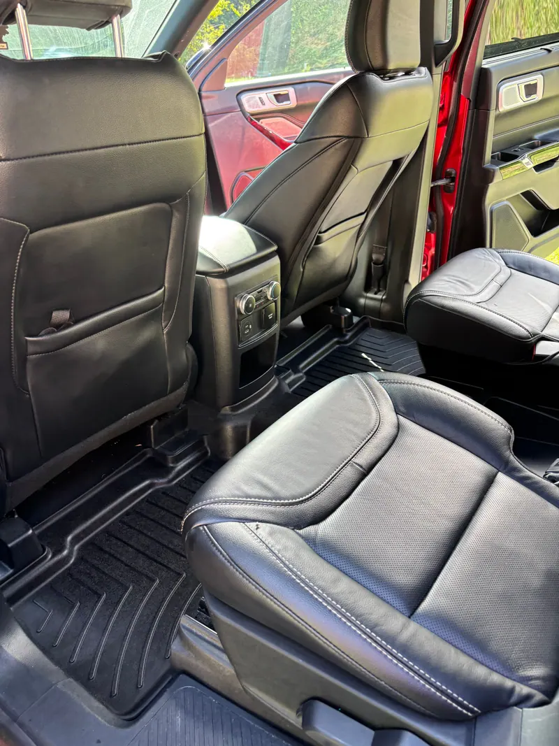 Rear seats of the Ford Explorer in black leather with rubber floor liners cleaned