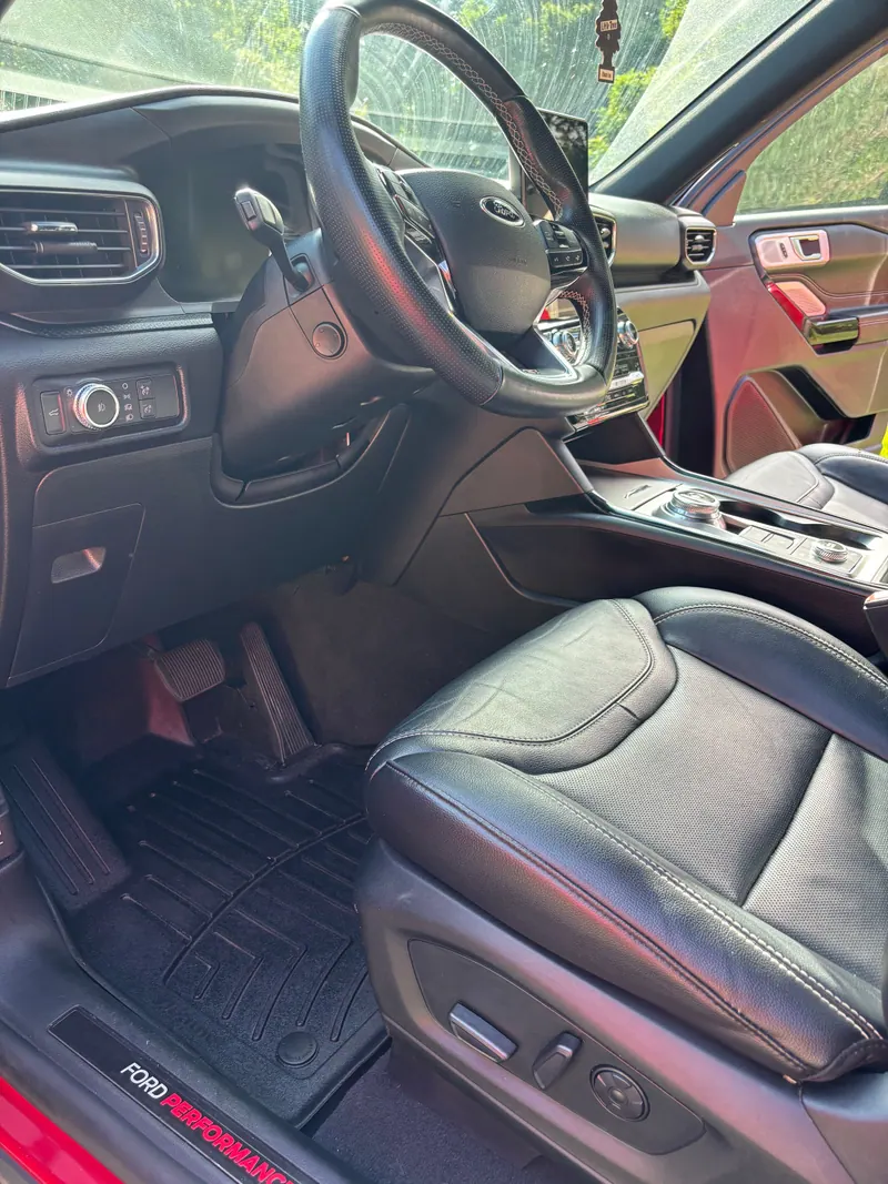 Ford Explorer driver's seat, steering wheel and console cleaned, Ford Performance sill plate visible