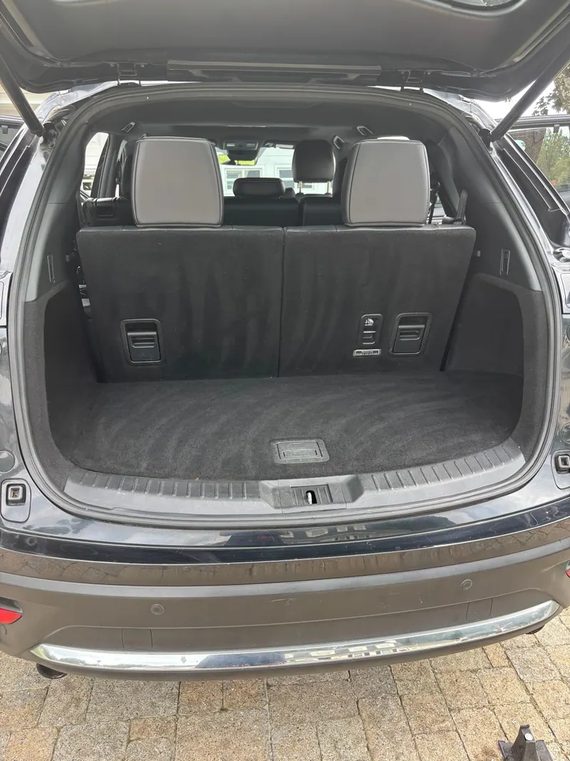 Cargo area of the Mazda CX-9 with the tailgate up, carpet vacuumed