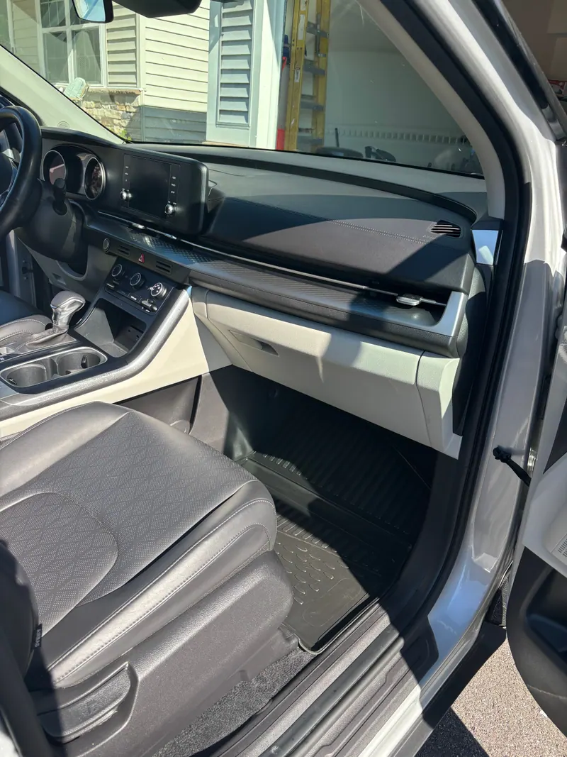 Passenger side dashboard and footwell cleaned, all-weather mat laid in