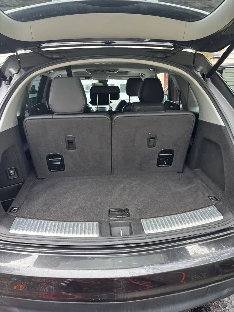 Cargo area of the Acura MDX with seats folded, carpet vacuumed and sill polished