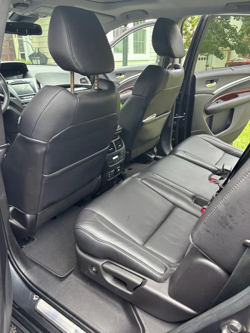 Rear seats of the Acura MDX in black leather, cleaned and conditioned