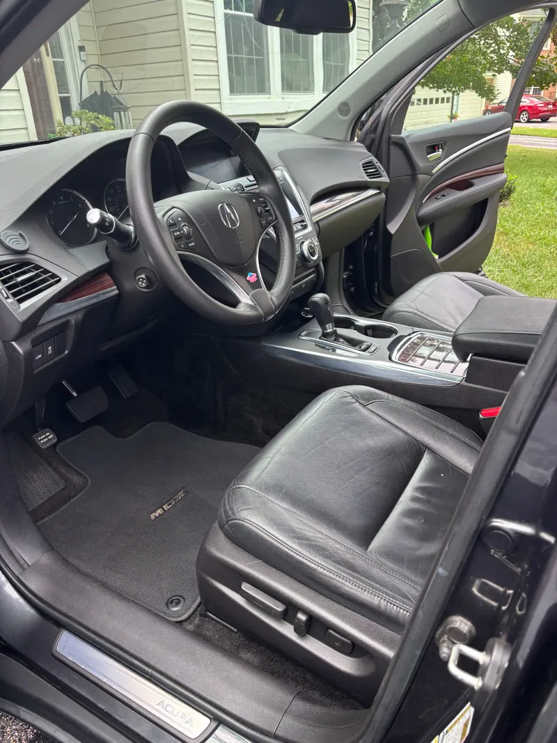 Acura MDX driver's seat, steering wheel and wood-trim dashboard cleaned
