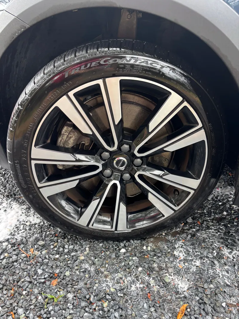 Close-up of a black alloy wheel on the Volvo, spokes cleaned and tyre dressed