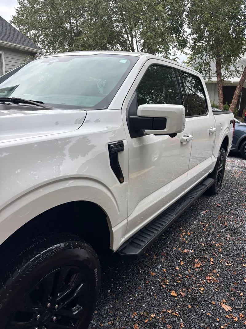 White Ford F-150 pickup in profile, body panels washed and paint gleaming