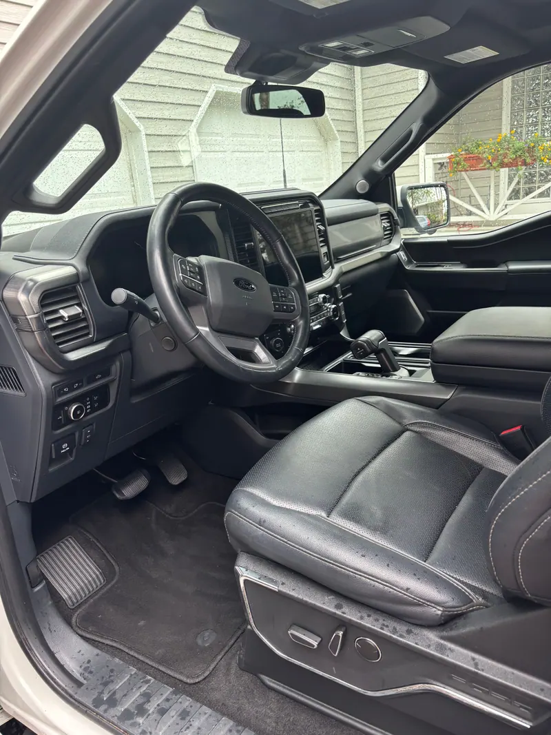 Ford F-150 driver's cabin with black leather seats and carpets vacuumed and dressed
