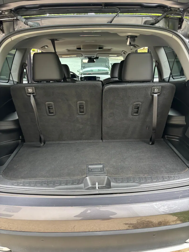 Cargo area of the Honda Pilot with the rear seats up, carpet vacuumed