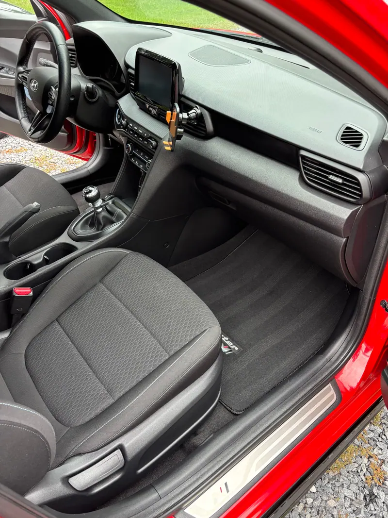 Hyundai Veloster passenger side showing the manual shifter, console and dashboard cleaned